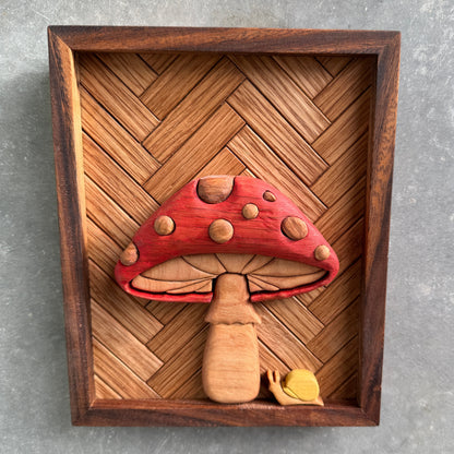Wooden frame with a red mushroom-shaped object on a gray background